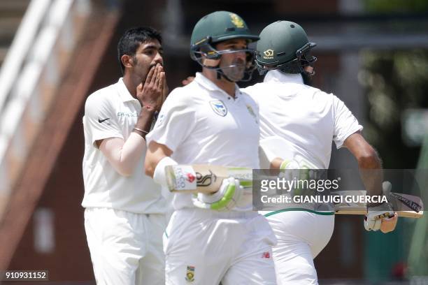 India's bowler Jasprit Bumrah reacts as South Africa's batsmen Dean Elgar and Hashim Amla take runs during the fourth day of the third cricket test...