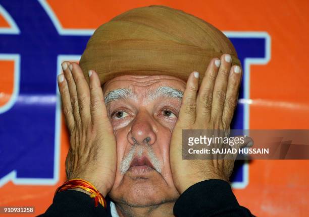 Rajput Karni Sena chief Lokendra Singh Kalvi gestures during a press conference in New Delhi on January 27, 2018. Thousands of police in riot gear...