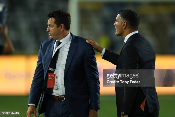 Paul Okon of the Mariners and John Aloisi of the Roar in discussion after the game during the round 18 A-League match between the Central Coast...