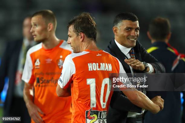 John Aloisi of the Roar congratulates Brett Holman of the Roar after the finish of the game during the round 18 A-League match between the Central...