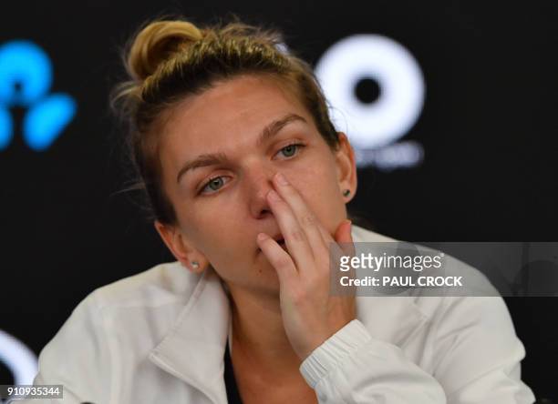Romania's Simona Halep reacts during a press conference after losing to Denmark's Caroline Wozniacki in their women's singles final match on day 13...