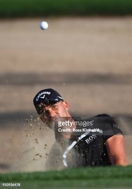 Haydn Porteous of South Africa plays his second shot from a bunker on the 15th hole during day three of Omega Dubai Desert Classic at Emirates Golf...
