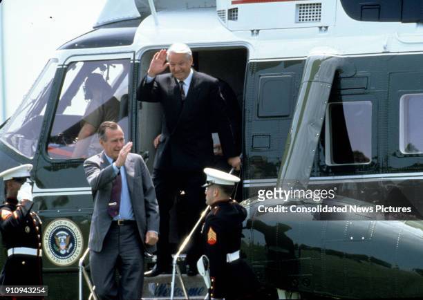 President George HW Bush and Russian Federation President Boris Yeltsin wave as they step off Marine One, Maryland, June 17, 1992.