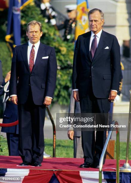 View of Czech President Vaclav Havel and US President George HW Bush on a reviewing stand on the White House's South Lawn during the former's State...