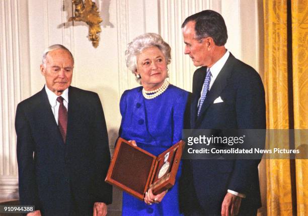 American sculptor and educator Walker Hancock is awarded the National Medal of Arts by US First Lady Barbara Bush and President George HW Bush during...