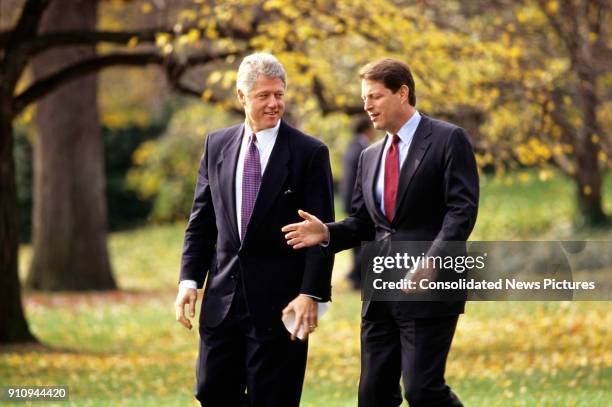 President Bill Clinton and Vice President Al Gore talk together as they walk on the White House's South Lawn, Washington DC, November 18, 1993.