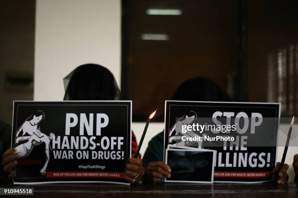 Relatives of people killed in the Philippine government's &quot;War on Drugs&quot; campaign hold placards to protest the impending resumption of the...