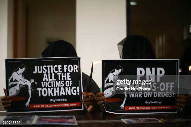 Relatives of people killed in the Philippine government's &quot;War on Drugs&quot; campaign hold placards to protest the impending resumption of the...