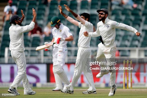 Indian Captain Virat Kohli and bowler Jasprit Bumrah celebrate the dismissal of South African batsman Ab de Villiers during the fourth day of the...