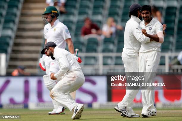 Indian Captain Virat Kohli and bowler Jasprit Bumrah celebrate the dismissal of South African batsman Ab de Villiers during the fourth day of the...