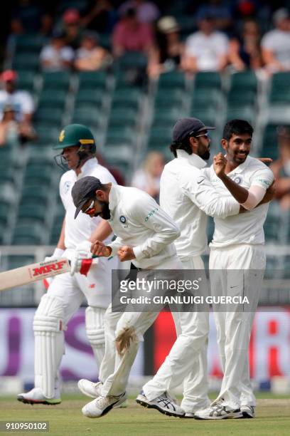 Indian Captain Virat Kohli and bowler Jasprit Bumrah celebrate the dismissal of South African batsman Ab de Villiers during the fourth day of the...