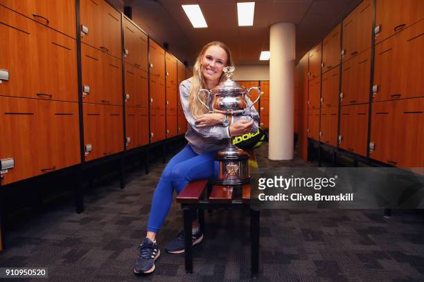 Caroline Wozniacki of Denmark poses with the Daphne Akhurst Trophy in the change-rooms after winning the Women's Singles Final against Simona Halep...