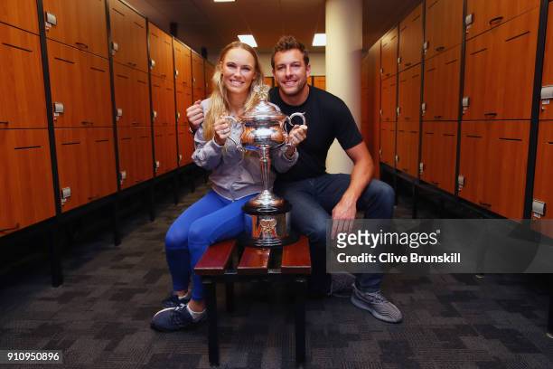 Caroline Wozniacki of Denmark and fiance David Lee pose with the Daphne Akhurst Trophy in the locker-room after winning the Women's Singles Final...