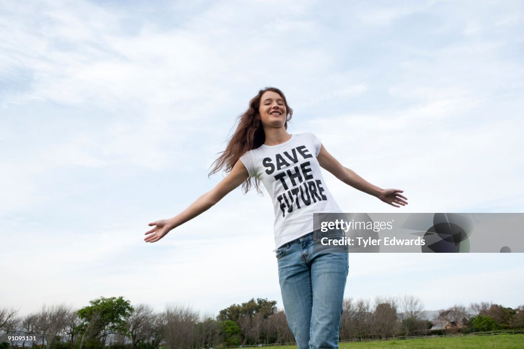 Woman running through green field