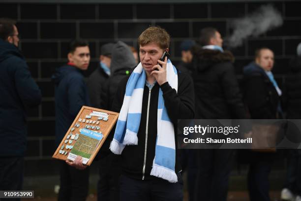 Man sells match day pins outside the stadium before th Emirates FA Cup Fourth Round match between Milton Keynes Dons and Coventry City at Stadium mk...