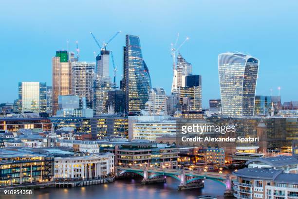 illuminated london skyline at dusk, greater london, uk - greater london stock-fotos und bilder