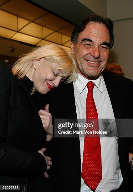 Actress Courtney Love and Director Oliver Stone pose for a photo at the after party for "South of the Border" premiere at the Walter Reade Theater on...