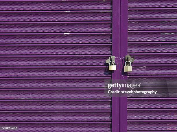 two padlocks on purple shutters - store closing stock pictures, royalty-free photos & images