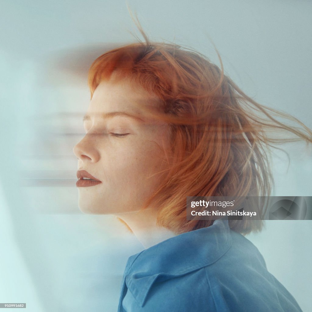 Red haired woman in motion, blurred motion - long exposure