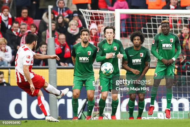 Milos Jojic of 1.FC Koeln scores his teams first goal over Aufsburgs wall to make it 1-0 during the Bundesliga match between 1. FC Koeln and FC...