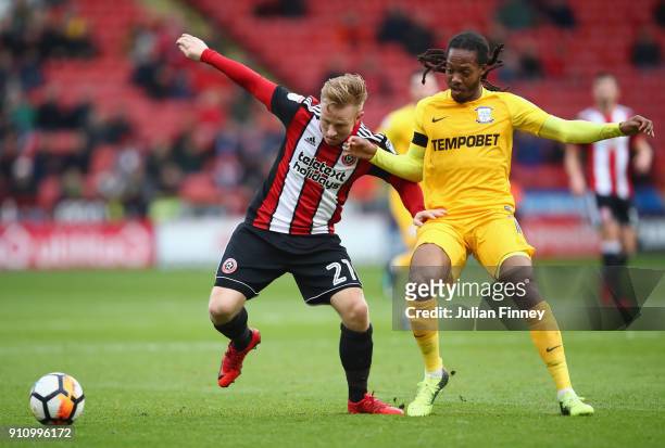 Mark Duffy of Sheffield United is challenged by Daniel Johnson of Preston North End during The Emirates FA Cup Fourth Round match between Sheffield...