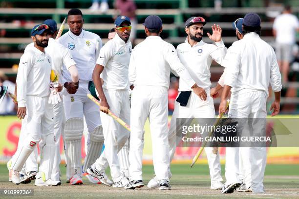 India's players celebrate after winning the fourth day of the third Test match between South Africa and India at Wanderers cricket ground in...