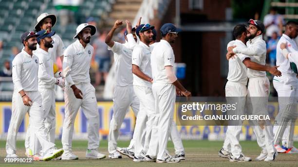 India's Captain Virat Kohli celebrates with teammates after winning the fourth day of the third Test match between South Africa and India at...