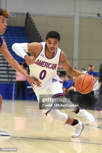Sa'eed Nelson of the American University Eagles dribbles the ball during a college basketball game against the Holy Cross Crusaders at Bender Arena...