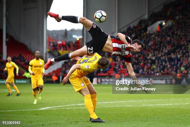 Ben Heneghan of Sheffield United collides with Paul Huntington of Preston North End during The Emirates FA Cup Fourth Round match between Sheffield...