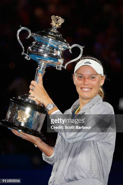 Caroline Wozniacki of Denmark poses with the Daphne Akhurst Memorial Cup after winning the women's singles final against Simona Halep of Romania on...
