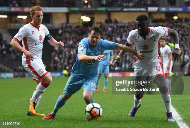 Marc McNulty of Coventry City is chased by Dean Lewington and Ousseynou Cisse of Milton Keynes Dons during The Emirates FA Cup Fourth Round match...