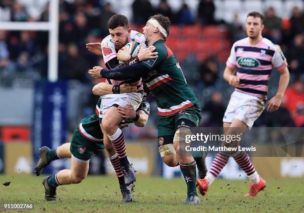 Aled Summerhill of Cardiff is tackled by Will Evans of Leicester Tigers during the Anglo-Welsh Cup match between Leicester Tigers and Cardiff Blues...