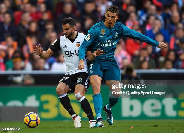 Martin Montoya of Valencia competes for the ball with Cristiano Ronaldo of Real Madrid during the La Liga match between Valencia and Real Madrid at...