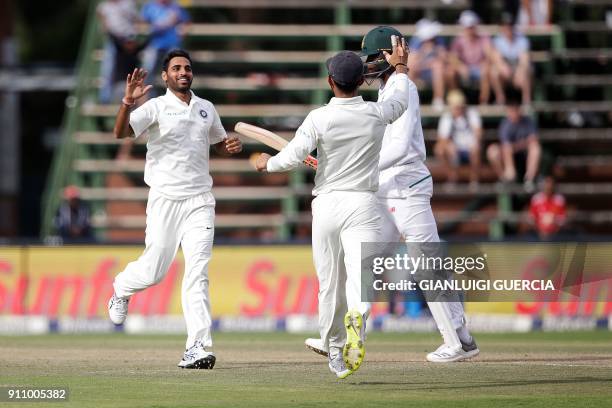 Indian bowler Bhuvneshwar Kumar celebrates the dismissal of South African batsman Kagiso Rabada during the fourth day of the third Test match between...