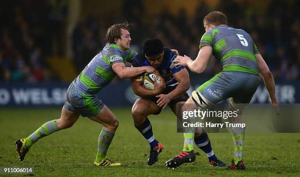 Ben Tapuai of Bath Rugby is tackled by Joel Hodgson and Andrew Davidson of Newcastle Falcons during the Anglo-Welsh Cup match between Bath and...