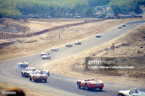 Action view of sports cars cruising along the track during the SCCA National Races in Bridgehampton, New York, May 31, 1959. At bottom center in red...