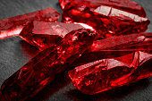 Closeup of a bunch of red rough uncut ruby crystals