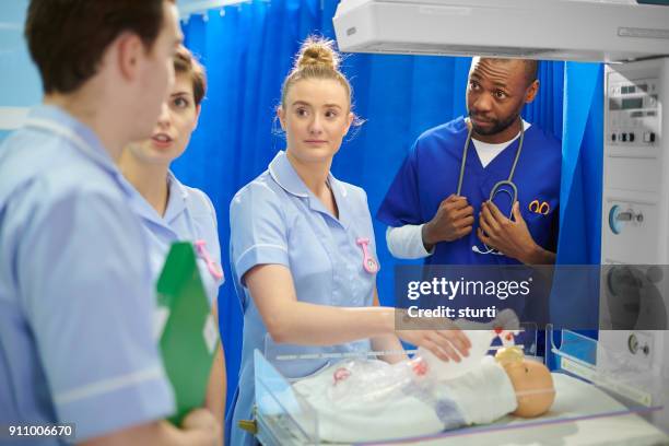 paediatric nursing students with infant simulator - simulates stock pictures, royalty-free photos & images