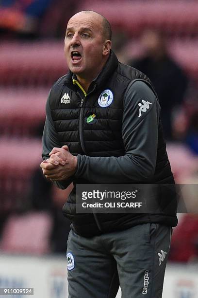Wigan Athletic's English Manager Paul Cook gestures on the touchline during the English FA Cup fourth round football match between Wigan Athletic and...