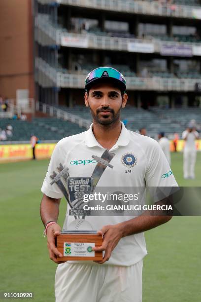Indian Bhuvneshwar Kumar poses with his trophy for Man of the Match after the fourth day of the third Test match between South Africa and India at...