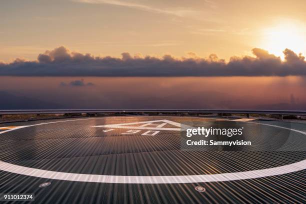 helipad beyond the clouds - hubschrauber landeplatz stock-fotos und bilder