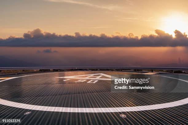 helipad beyond the clouds - helikopterplatform stockfoto's en -beelden