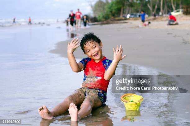 little boy having fun time at the beach - kota kinabalu beach stock pictures, royalty-free photos & images