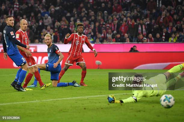Kingsley Coman of Bayern Muenchen scores a goal past Oliver Baumann of Hoffenheim to make it 3:2 during the Bundesliga match between FC Bayern...