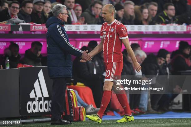 Arjen Robben of Bayern Muenchen shakes the hand of Jupp Heynckes, head coach of Bayern Muechen, as he comes off during the Bundesliga match between...