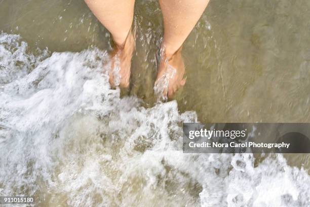 pov top view of waves and foot at the beach - kota kinabalu beach stock pictures, royalty-free photos & images