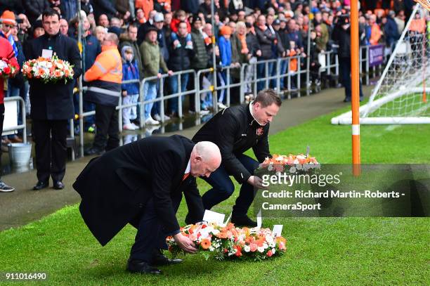 Former Blackpool player Derek Spence lays a wreath in front of the Armfield stand during the Sky Bet League One match between Blackpool and Charlton...