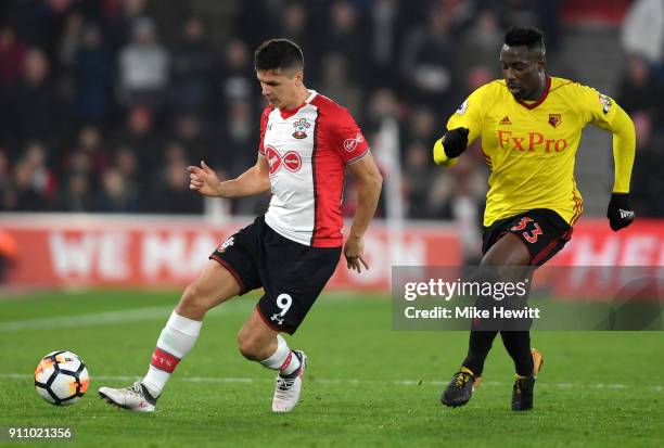 Stefano Okaka of Watford chases down Guido Carrillo of Southampton during The Emirates FA Cup Fourth Round match between Southampton and Watford at...