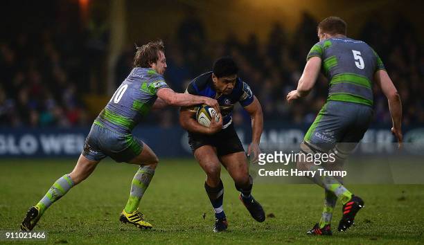 Ben Tapuai of Bath Rugby is tackled by Joel Hodgson and Andrew Davidson of Newcastle Falcons during the Anglo-Welsh Cup match between Bath and...
