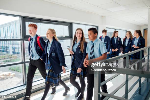 walking to class - school uniform stock pictures, royalty-free photos & images